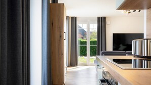 Eine moderne Küche mit einer Holzarbeitsplatte, Edelstahlgeräten und einem großen Fenster.