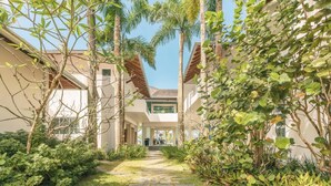 A pathway leading to a building with a modern architectural style, surrounded by lush greenery and palm trees. - So Exclusive Beachfront Villa at Las Terrenas (Las Terrenas)
