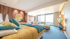 A hotel room with a large bed, a bedside table, a mirror, and a view of the outside. - 1 Bed in Oban (oc-t41733) (Achacha)