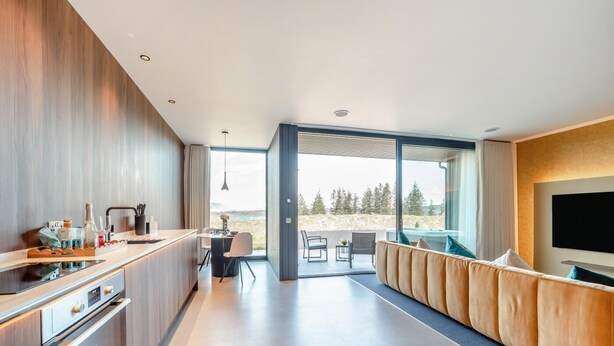 A modern kitchen with a dining area, a sofa, and a TV. - 1 Bed in Oban (oc-t41733) (Achacha)