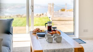 A breakfast table with croissants, coffee cups, and a French press. - 3 Bed in Ravenscar (oc-w41046) (Ravenscar)