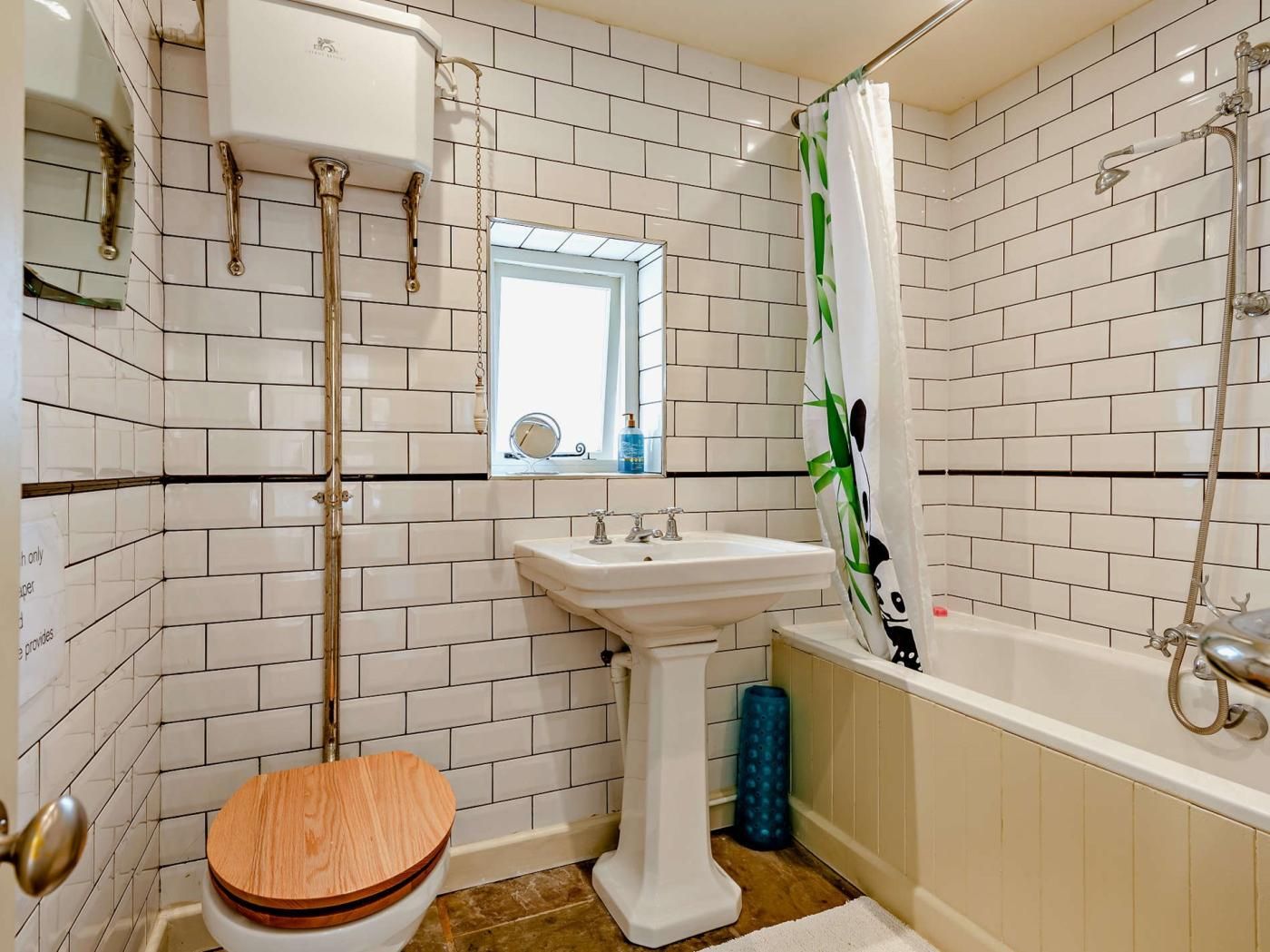 A bathroom with a toilet, sink, and bathtub.