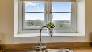 A kitchen with a window, a sink, and a potted plant. - 1 Bed in Edlingham (oc-g41396) (Edlingham)