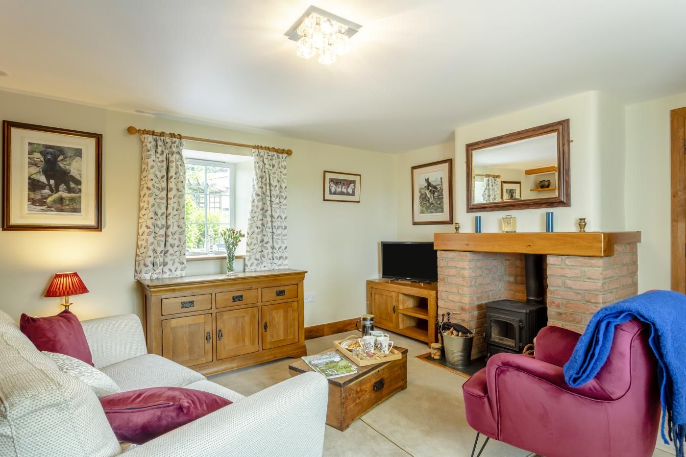 A cozy living room with a fireplace, a television, and a comfortable seating area.