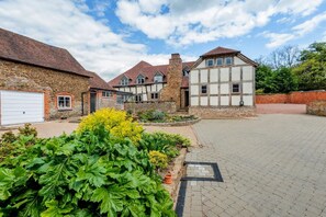 A residential property with a stone facade, a large garage, and a paved driveway.