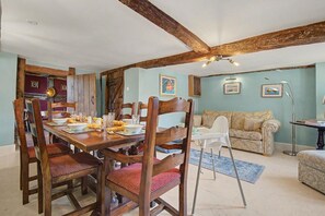 A dining area with wooden chairs and a table set for a meal. - 6 Bed in Storridge (oc-c39005) (Storridge)
