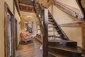 A staircase with wooden railings and a stone wall. - 6 Bed in Storridge (oc-c39005) (Storridge)