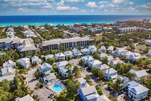 An aerial view of a coastal residential area with houses, a swimming pool, and a view of the ocean. - Close to Trails and Lakes with Shared Pool (Santa Rosa Beach)