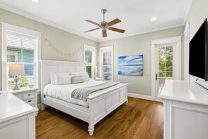 A bedroom with a bed, a ceiling fan, a painting, and a TV. - Close to Trails and Lakes with Shared Pool (Santa Rosa Beach)