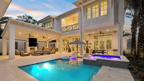 A two-story house with a swimming pool, outdoor seating, and a covered patio area. - Private Pool, Peloton, Sauna and LSV (Alys Beach)