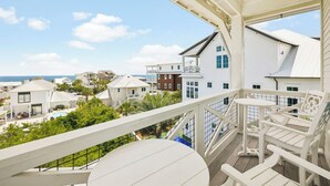 A balcony with a view of a coastal residential area, including houses and a swimming pool. - Private Pool, Peloton, Sauna and LSV (Alys Beach)