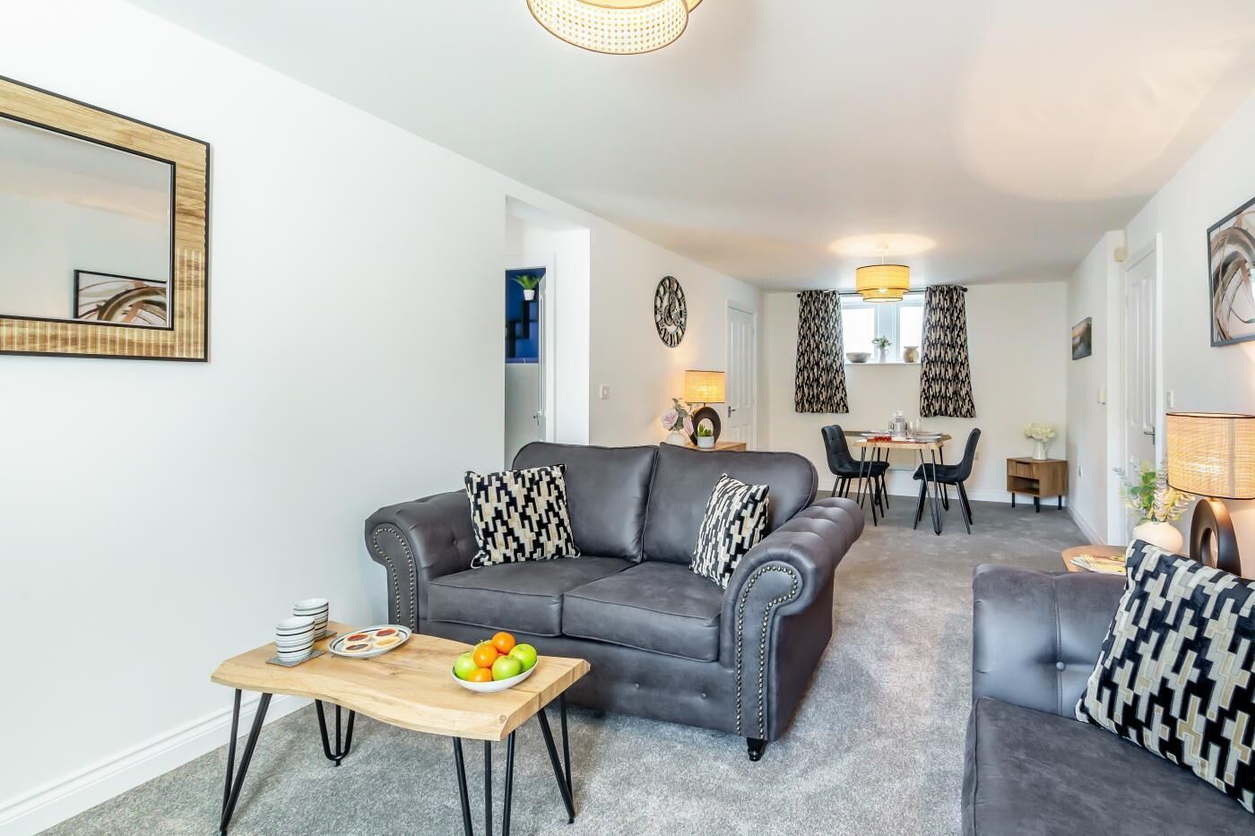 A modern living room with a sofa, a dining table, and a coffee table.