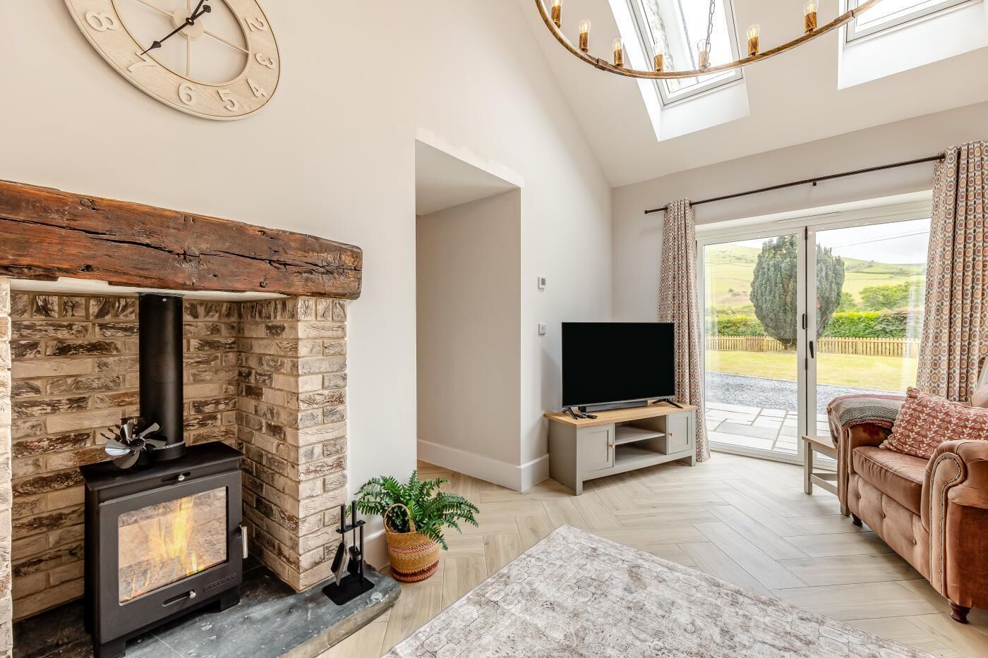 A living room with a fireplace, TV, and a sofa.