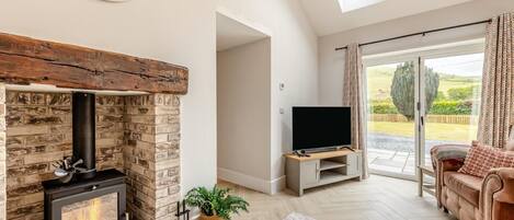 A living room with a fireplace, TV, and a sofa.
