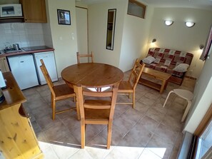 A compact kitchen with a dining table and chairs, a sofa, and a small refrigerator. - Apartment for 4 People in Val Cenis (Val-Cenis)