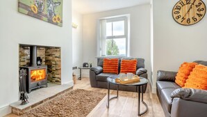 A living room with a fireplace, a sofa, a coffee table, and a clock on the wall. - 2 Bed in Consett (oc-b42654) (Consett)
