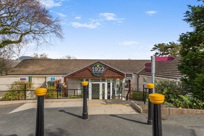 A building with a sign reading '1922 BAR & KITCHEN' at the entrance.