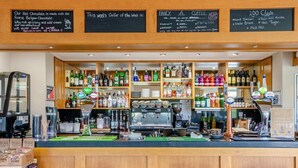 A bar with a variety of liquor bottles, a coffee machine, and a chalkboard menu. - 1 Bed in Lancashire (oc-w37869) (Bentham)