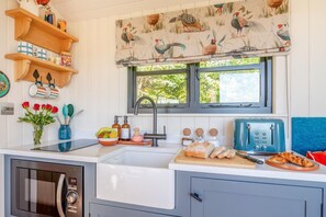 A compact kitchen with a built-in oven, a sink, and a window with a view of greenery. - 1 Bed in Newall With Clifton (oc-t42700) (Newall With Clifton)