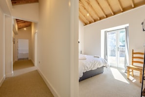 A bedroom with a bed, a chair, and a sliding glass door to an outdoor area. - 2 Bed in Barrow (oc-b42642) (Barrow)