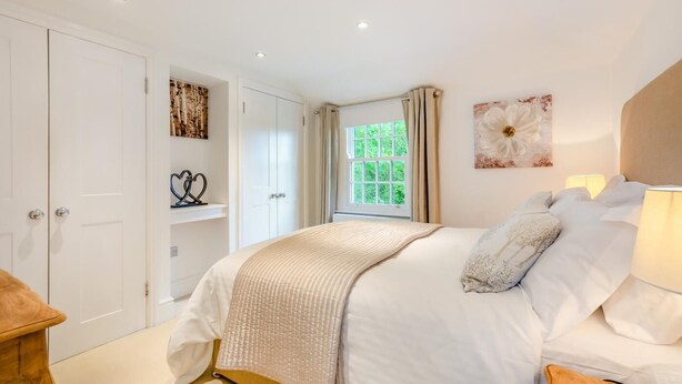 A bedroom with a bed, a window, a door, and a wall with artwork. - 2 Bed in Matfield (oc-s42710) (Matfield)