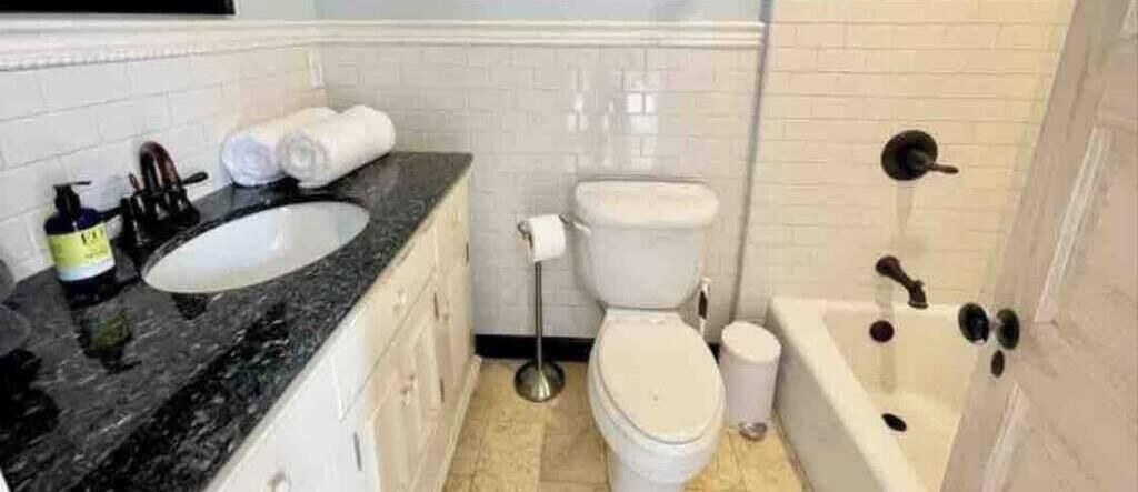 A bathroom with a sink, toilet, and bathtub.