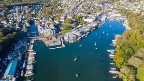 An aerial view of a coastal town with a marina, residential areas, and a bridge connecting two parts of the town. - 2 Bed in Goldenbank (oc-t42750) (Goldenbank)