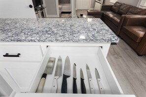 A kitchen with a marble countertop and a drawer with knives. - Single Level Ranch - 2 Bedroom Home - sleeps 4 (North Kansas City)