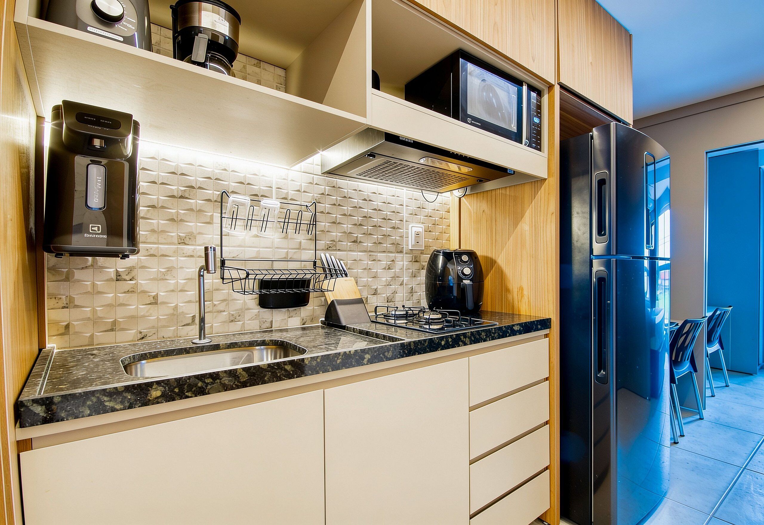 A modern kitchen with a built-in microwave, stainless steel appliances, and a gas stove.