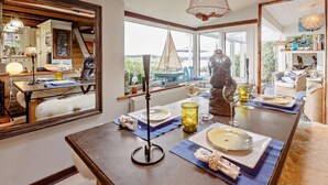 A dining area with a table set for two, a large mirror, and a view of the outdoors. - 2 Bed in Y Felinheli (oc-40860) (Y Felinheli)