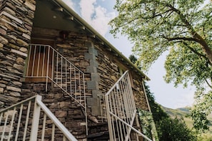 A stone building with a staircase and metal railings. - 2 Bed in Grasmere (oc-lr246) (Penrith)