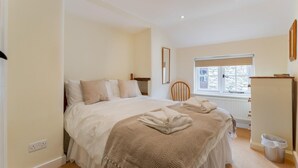 A bedroom with a bed, a window, a chair, a radiator, and a trash bin. - 1 Bed in Troutbeck (oc-lr027) (Troutbeck)