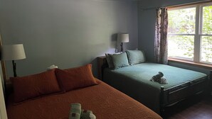 A room with two beds, a window with curtains, and a lamp on each bed. - 2bedroom home, lake access, snowmobile trail access, ac/fire place,  Indian Lake (Indian lake)