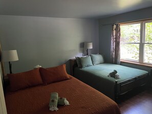 A room with two beds, a window with curtains, and a lamp on each bed. - 2bedroom home, lake access, snowmobile trail access, ac/fire place,  Indian Lake (Indian lake)