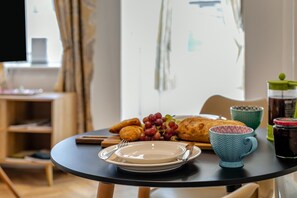 A dining table with a plate, a cup, a jar, and a loaf of bread. - 1 Bed in St. Ives (oc-l43758) (St Ives)