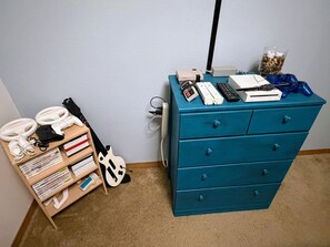 A room with a blue dresser, a guitar, and various electronic devices. - Secluded Woodland Retreat for 6 Near Wisconsin Dells, Lakes & ATV Trails (New Lisbon)