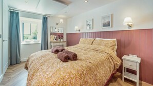 A bedroom with a bed, a nightstand, a dresser, and a window with curtains. - 1 Bed in Stewarton (oc-c44699) (Stewarton)