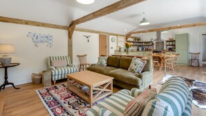 A spacious living room with a sofa, armchairs, a coffee table, and a patterned rug. - 2 Bed in Hartest (oc-w42830) (Hartest)