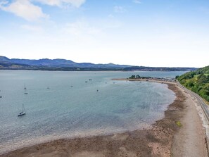 A coastal landscape with a beach, boats, and distant mountains. - 5 Bed in Beaumaris (oc-s44705) (Beaumaris)