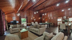 A spacious room with wooden walls, a pool table, sofas, and a billiards table. - 3 Bed in Llanrwst (oc-a43648) (Llanrwst)