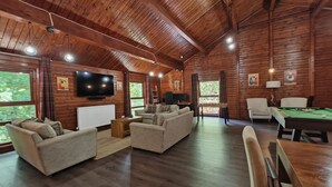 A spacious room with wooden walls, a sofa set, a pool table, and a television. - 3 Bed in Llanrwst (oc-a43648) (Llanrwst)