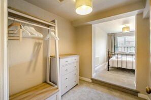 A bedroom with a bed, a walk-in closet, and a view of a balcony. - 3 Bed in Newnham (oc-r41757) (Newnham-on-Severn)