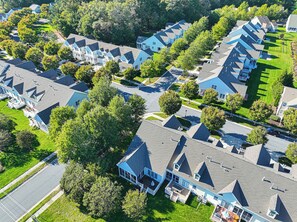 A residential area with multiple houses, each featuring a gabled roof and a front porch. - Pond View Bear Trap Home- 4BR 3.5BA - Screened Porch - Near Bethany Beach & Golf (Ocean View)