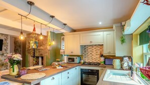 A modern kitchen with a central island, built-in appliances, and pendant lighting. - 2 Bed in East Morton (oc-m42778) (East Morton)