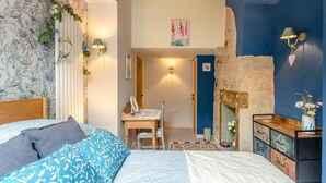 A bedroom with a bed, bedside tables, a dresser, a nightstand, a chair, a desk, a fireplace, and a wall with a floral pattern. - 2 Bed in East Morton (oc-m42778) (East Morton)