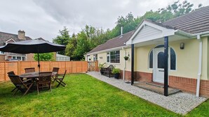 A house with a covered patio, a lawn, and a fenced backyard. - 1 Bed in Winterborne Zelston (oc-r43274) (Winterborne Zelston)