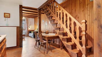 A wooden staircase with a traditional design, leading to an upper floor.