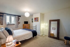 A bedroom with a bed, bedside table, lamp, dresser, mirror, and a wall-mounted light fixture. - 2 Bed in Bradley (oc-w44709) (Skipton)