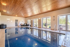 A swimming pool with a wooden ceiling and large windows. - 7 Bed in Awre (oc-b42471) (Awre)