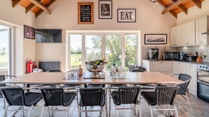 A spacious kitchen with a large island, modern appliances, and a view to the outdoors. - 7 Bed in Awre (oc-b42471) (Awre)